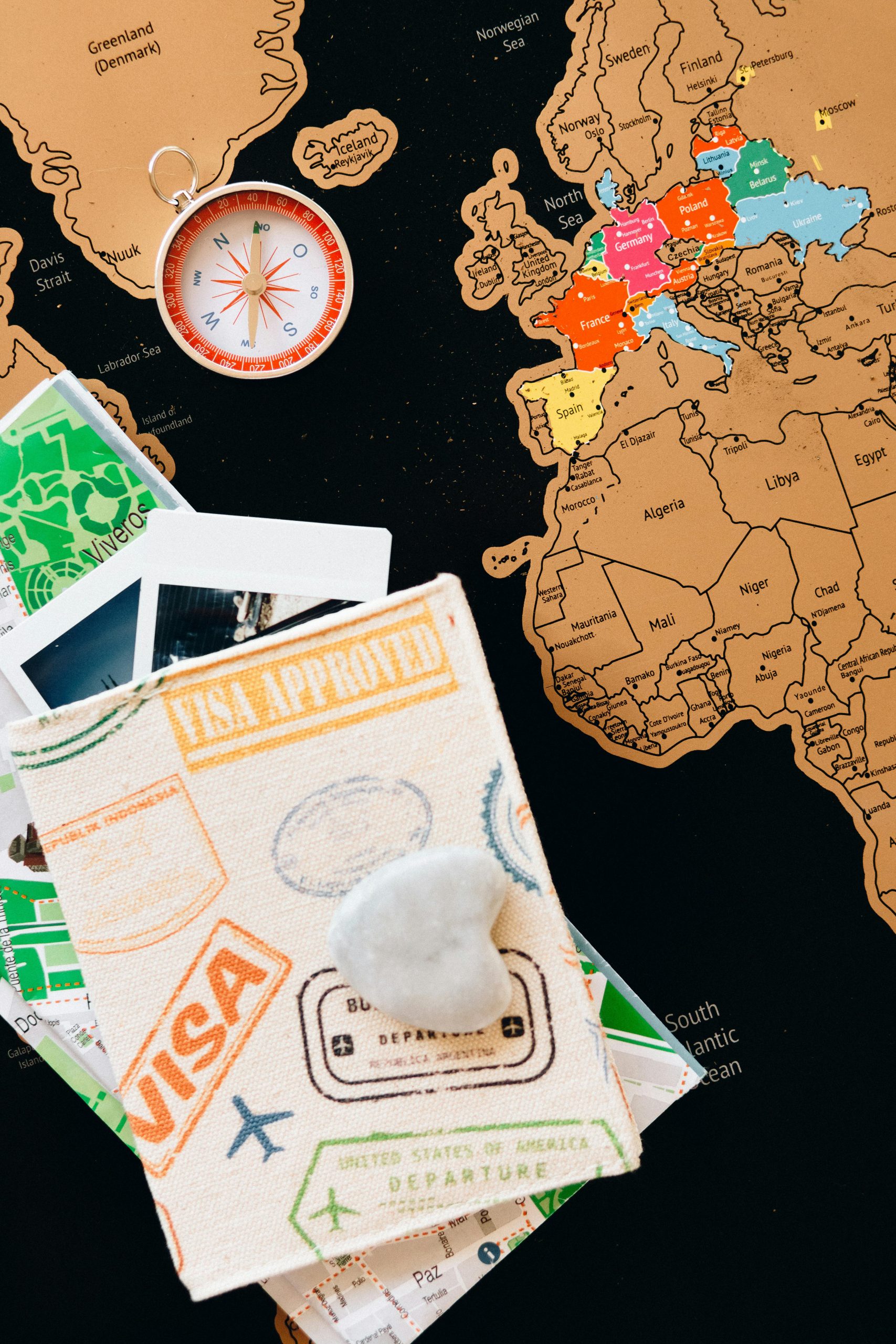 Explore the world with this colorful travel map, compass, and passport stamps.